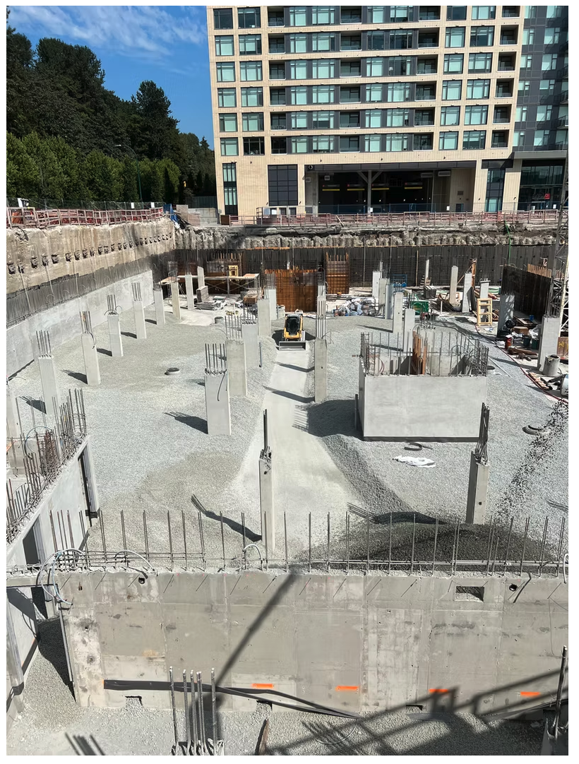 Deep shored foundation excavation with rebar columns beneath a Lower Mainland residential tower