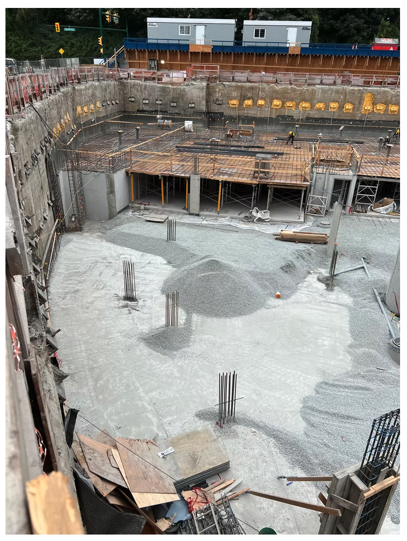 Shored basement excavation with soldier piles, formwork and rebar for a multi-family concrete structure