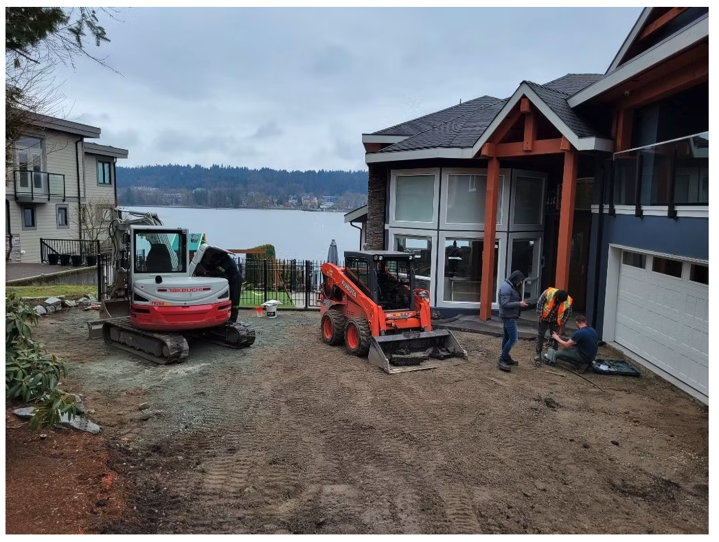 Takeuchi excavator and Kubota skid steer removing driveway subgrade at a waterfront home